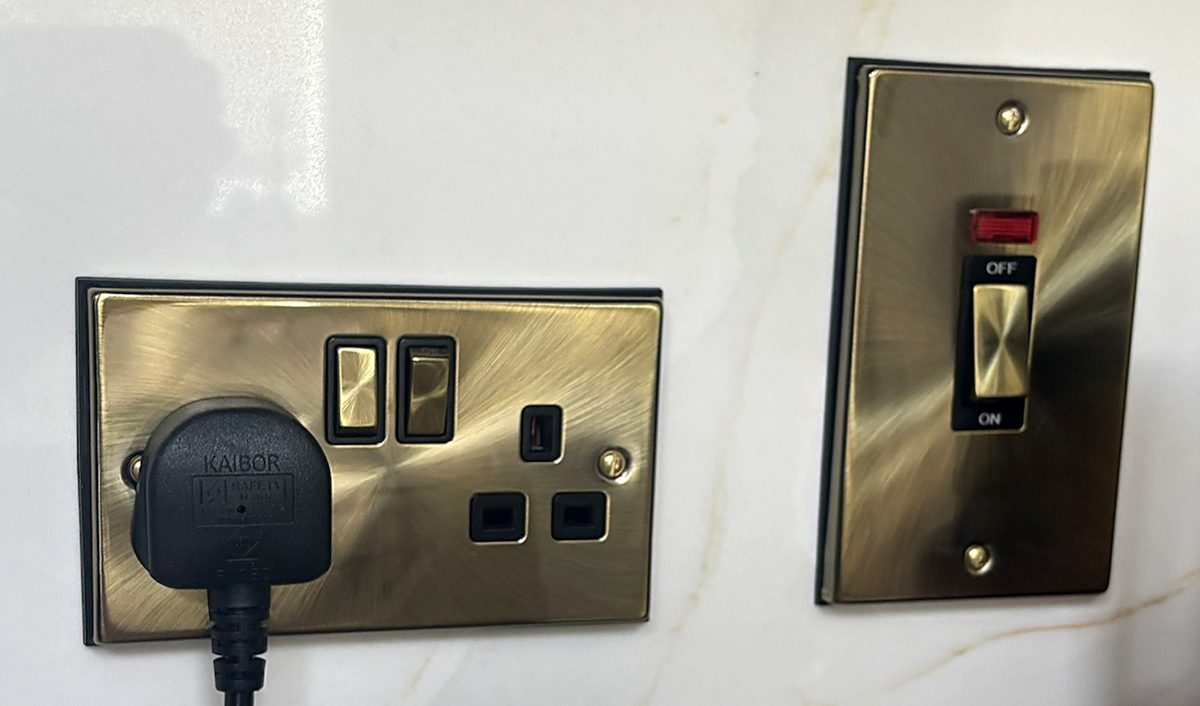 Antique brass double socket and cooker switch with red neon