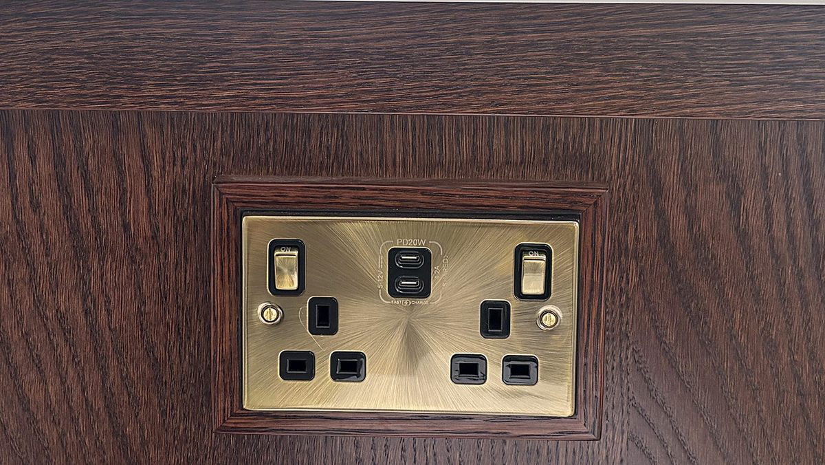 Antique brass double socket with USB-C on an oak kitchen island